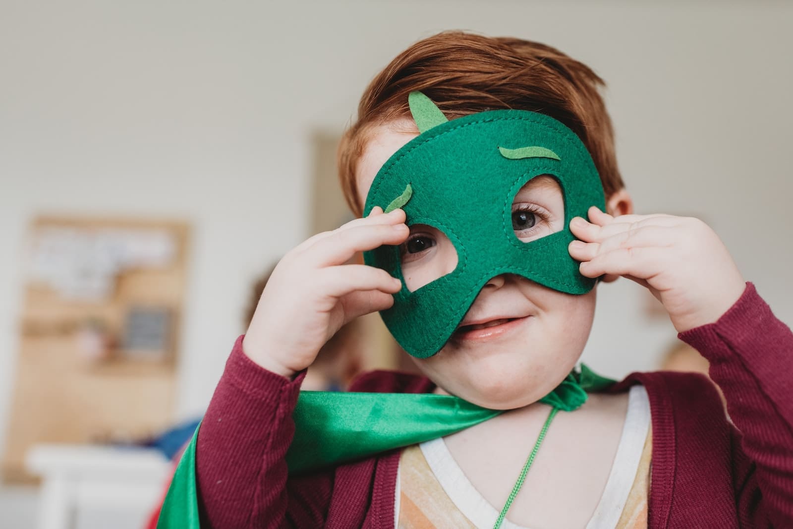 innocent boy holding green mask