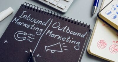 inbound marketing vs outbound marketing written as a comparison on a black surface