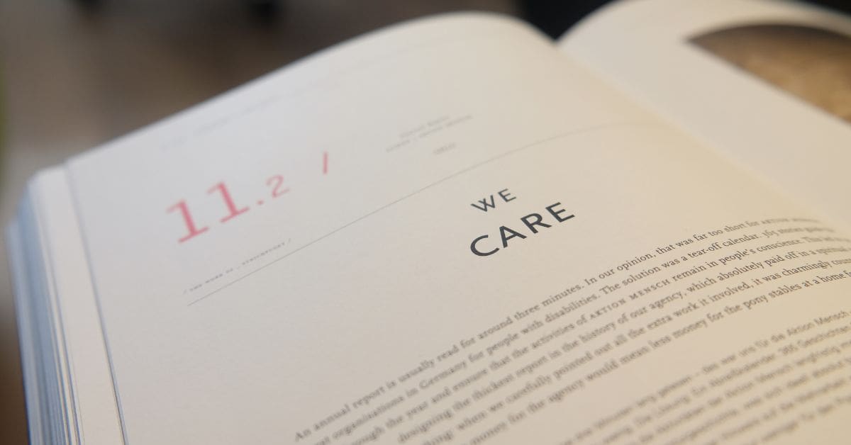 Close up of a book with the words "WE CARE" written on the cover. Symbol of caring and compassion.