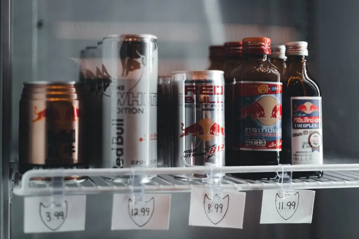 a display shelf with red bull, an explorer brand, on sale