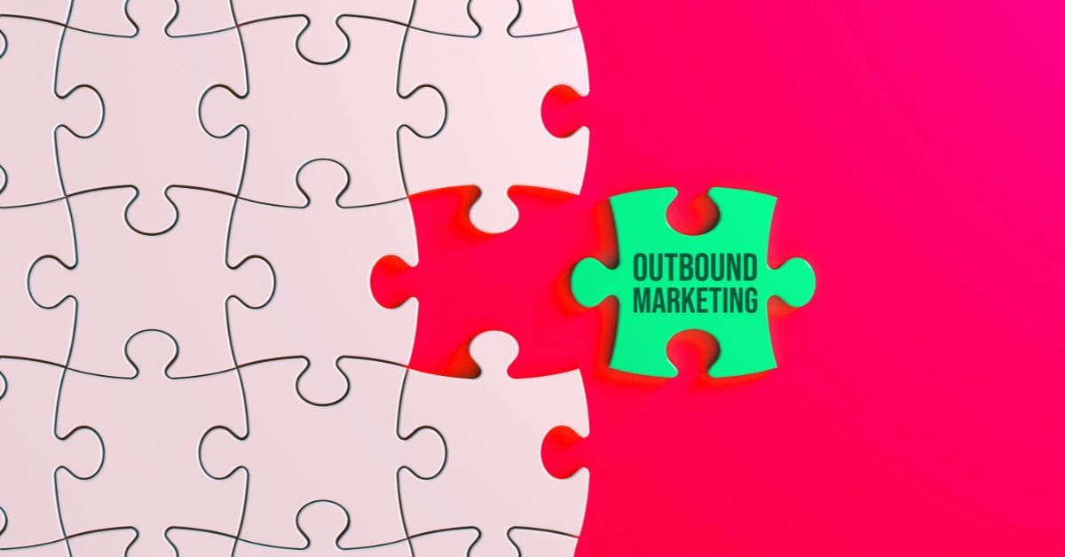 puzzle piece with the word outbound marketing on it, on a pink and red background