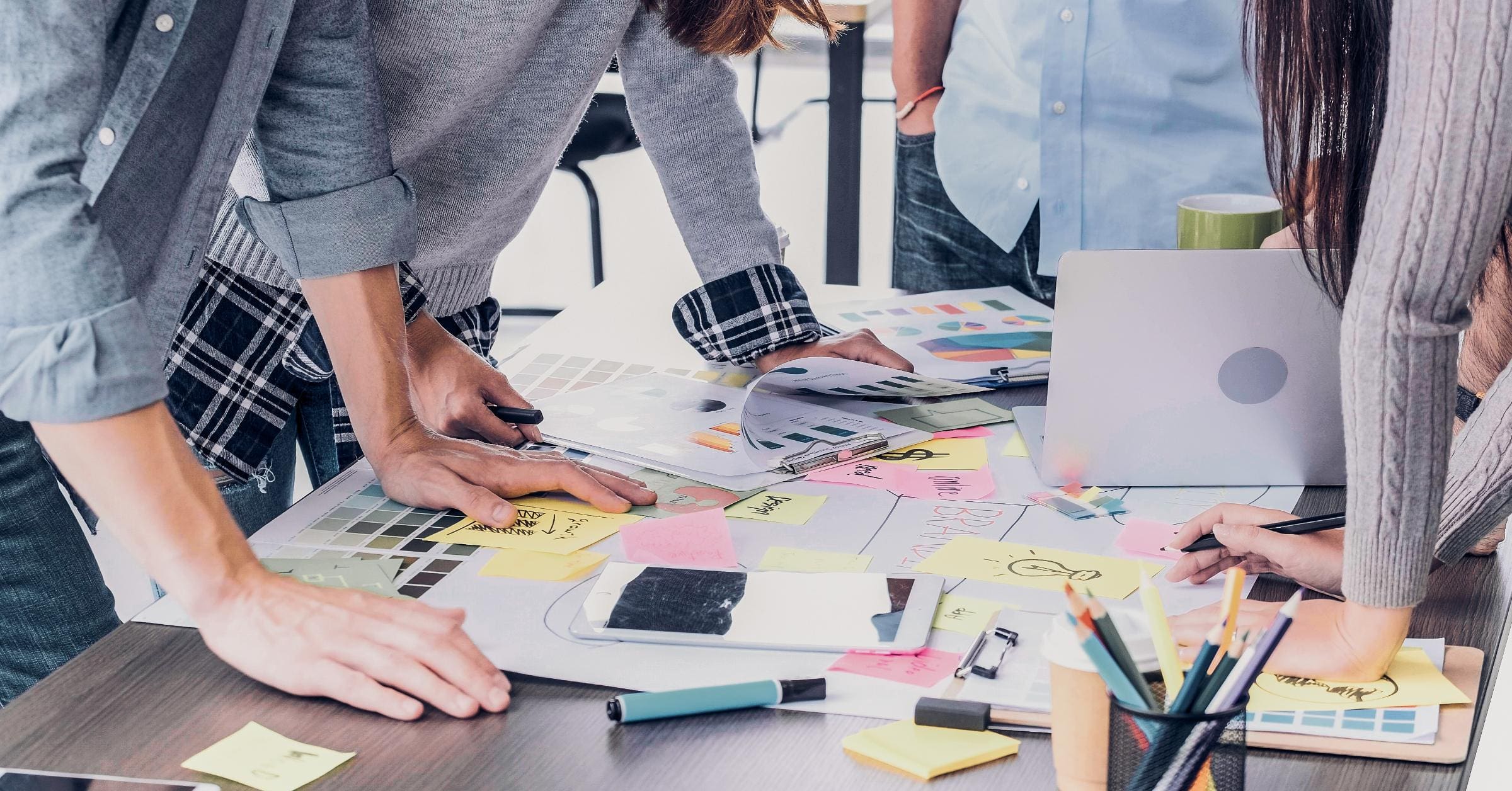 A team of creative professionals, including designers and marketers, working together on a branding project, with a focus on their collaborative process and the visual elements they are creating, such as color palettes and typography.